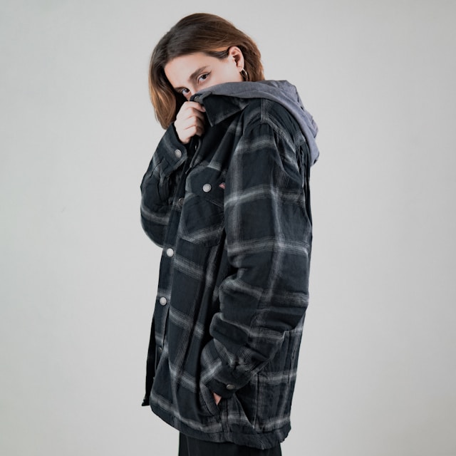 Person using a pen to cross a task off a productivity paper card.