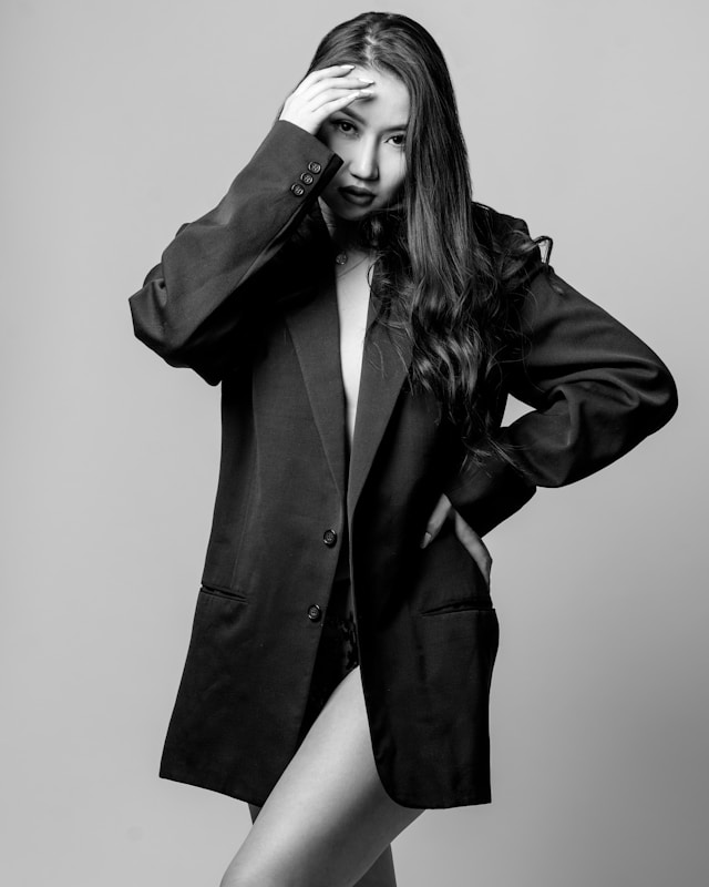 Hand holding black machined steel mechanical pencil with brass tip and top.