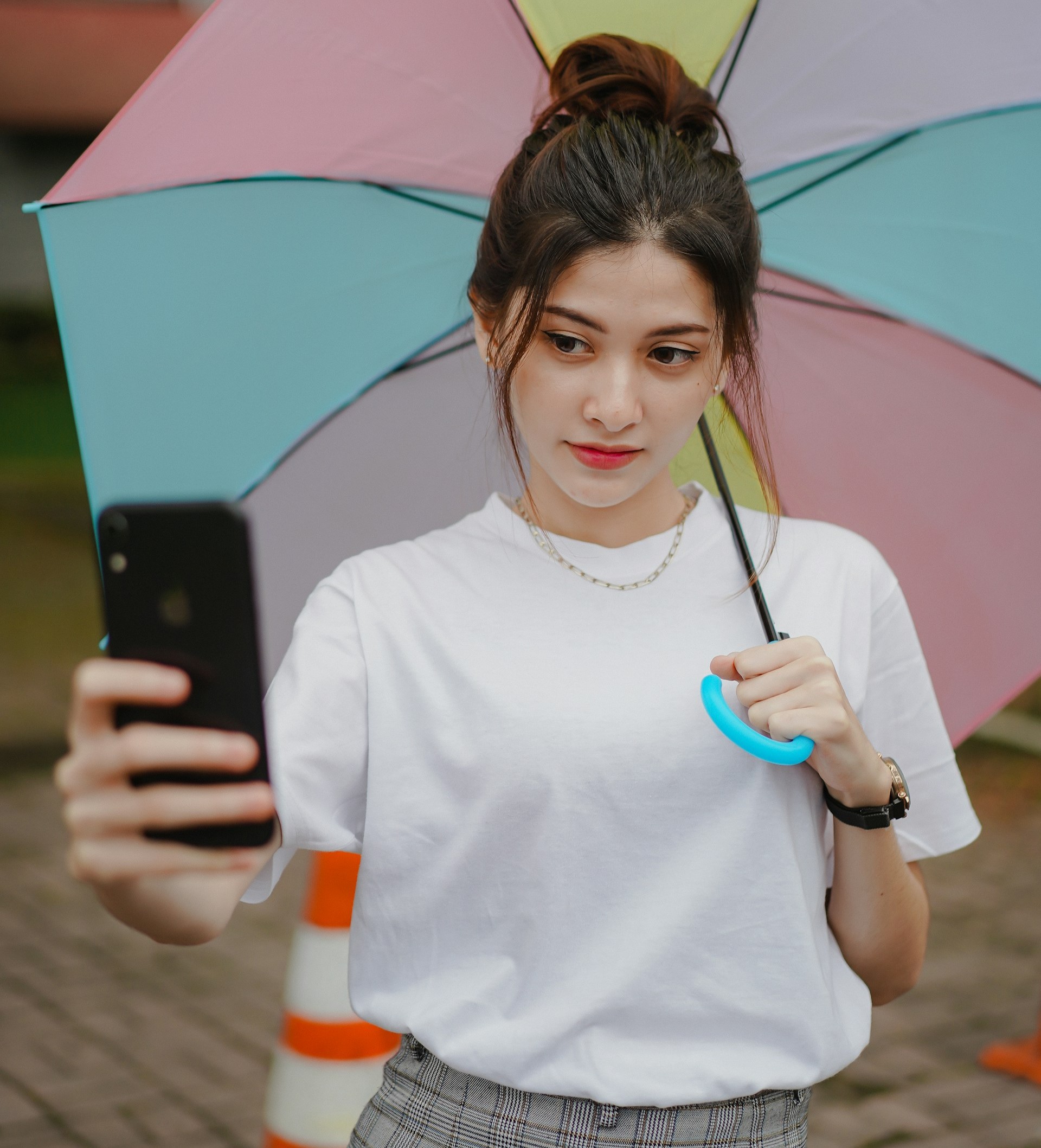 Desk with leather desk pad, walnut desk organizer, wireless keyboard and mouse, and porcelain mug.