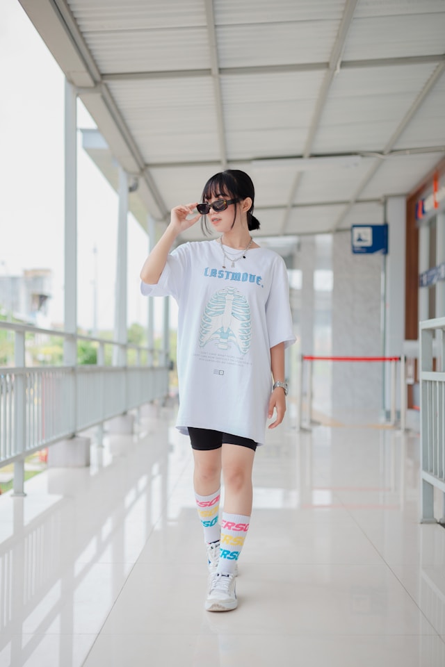 Hand holding black machined steel mechanical pencil with brass tip and top.